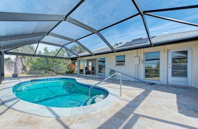 view of swimming pool with a lanai and a patio area