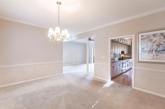 interior space featuring crown molding, ceiling fan with notable chandelier, baseboards, and light colored carpet