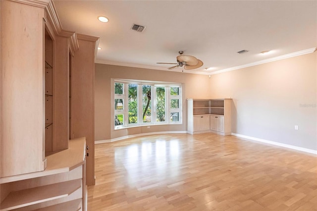 unfurnished living room with visible vents, baseboards, a ceiling fan, light wood finished floors, and crown molding