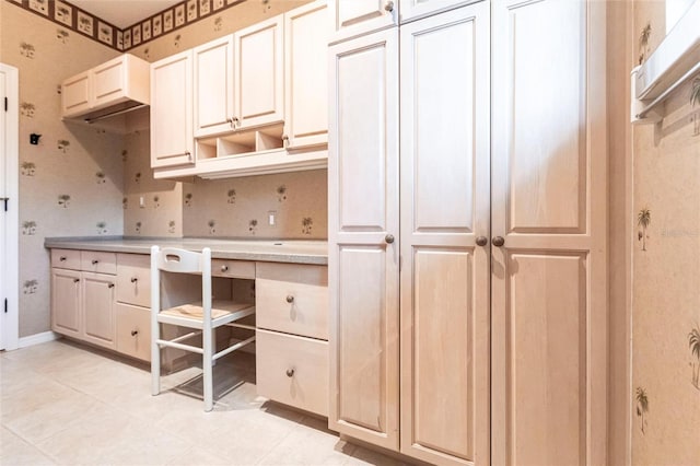 kitchen featuring light countertops, baseboards, and open shelves