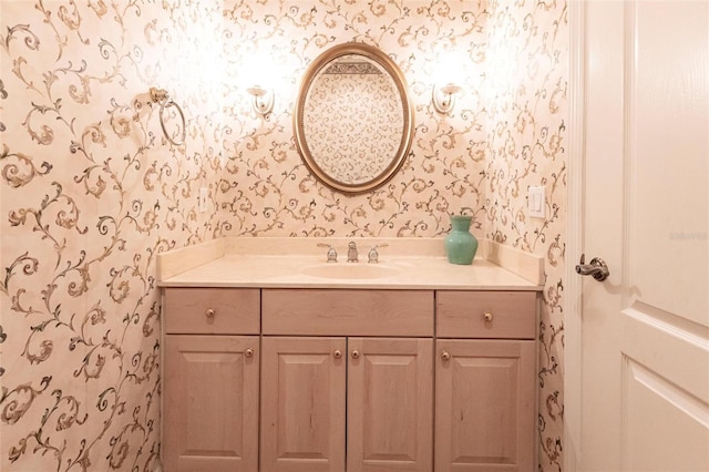 bathroom with vanity and wallpapered walls