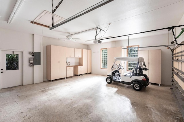 garage with a garage door opener and electric panel