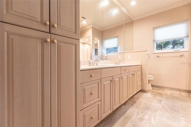 full bathroom featuring toilet, a sink, baseboards, ornamental molding, and double vanity