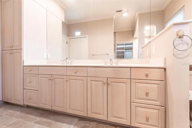 full bathroom with double vanity, visible vents, and crown molding