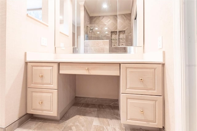 full bathroom featuring ornamental molding, tiled shower, and vanity