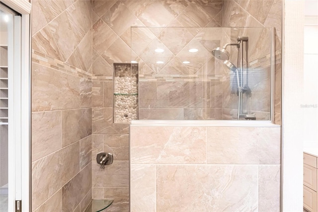 details featuring tiled shower and vanity