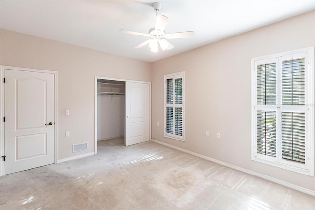 unfurnished bedroom with a closet, visible vents, carpet flooring, ceiling fan, and baseboards