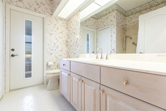 bathroom featuring tile patterned floors, vanity, toilet, and wallpapered walls