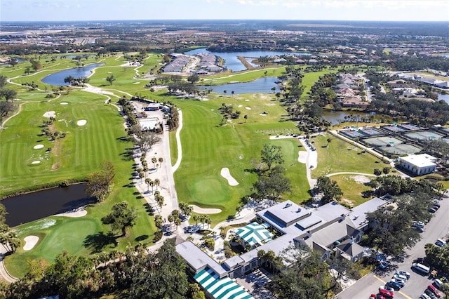 birds eye view of property with view of golf course and a water view