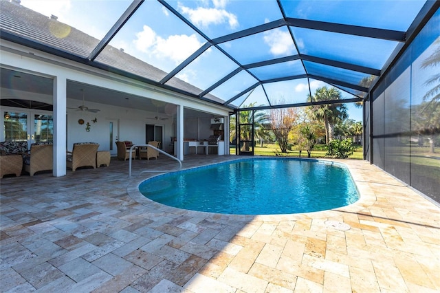 pool with a lanai, a patio area, and ceiling fan