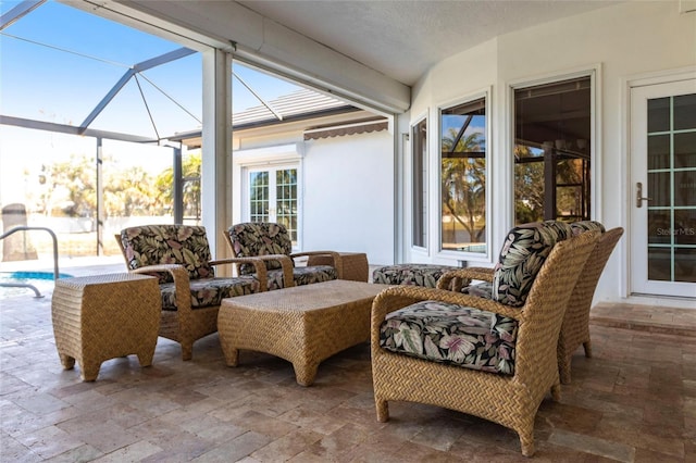 view of patio with a lanai, an outdoor pool, and outdoor lounge area