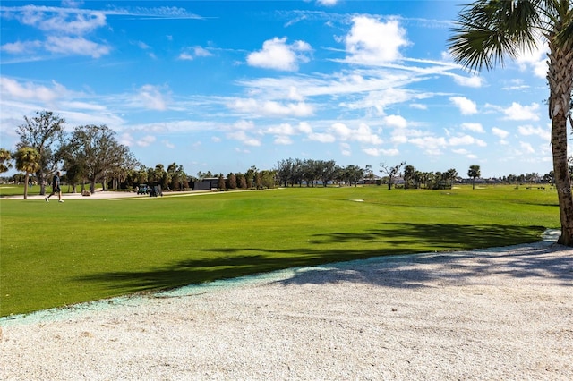 view of community featuring a yard and golf course view