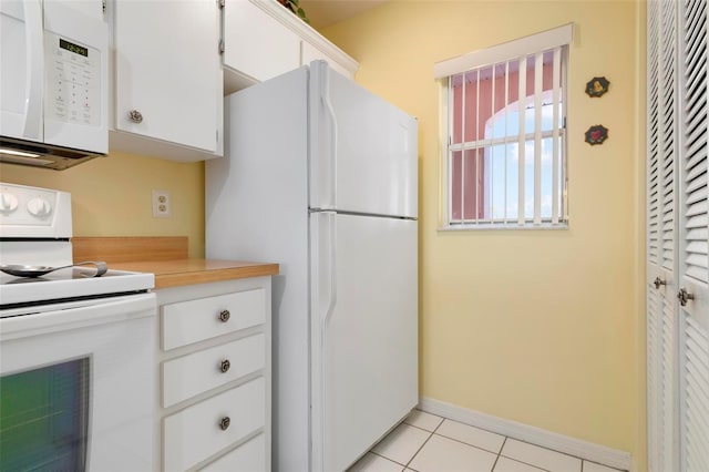 kitchen featuring white cabinetry, white appliances, and light tile patterned floors