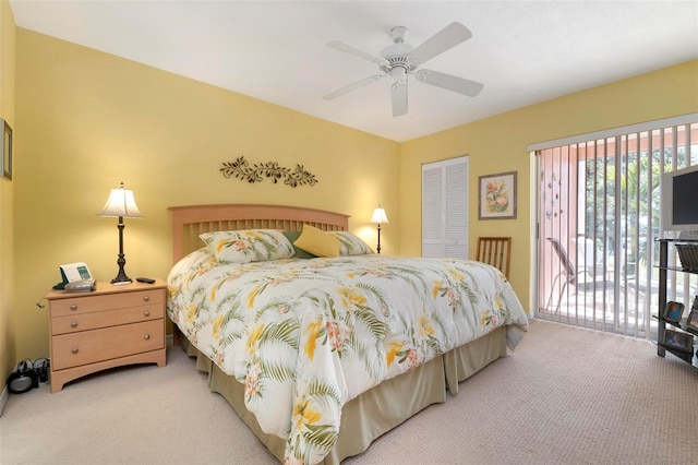 carpeted bedroom with access to exterior, ceiling fan, and a closet