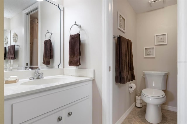 bathroom featuring vanity, toilet, and tile patterned flooring