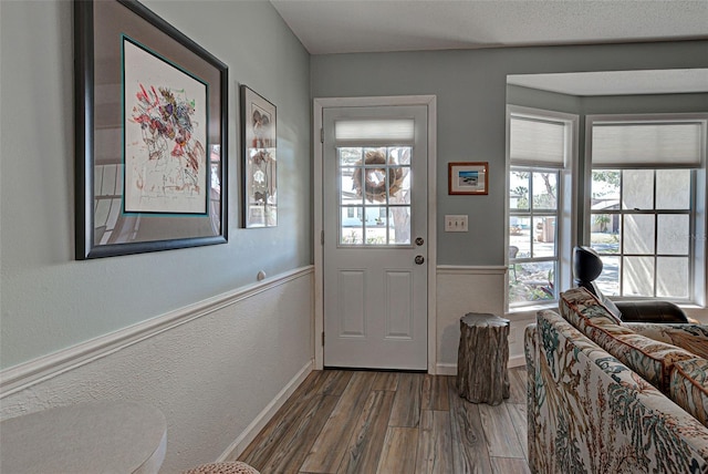 doorway to outside with wood-type flooring