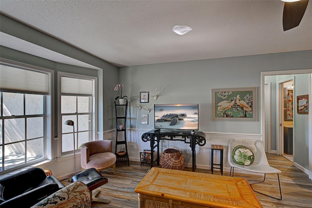 interior space with a fireplace, a textured ceiling, and light wood-type flooring