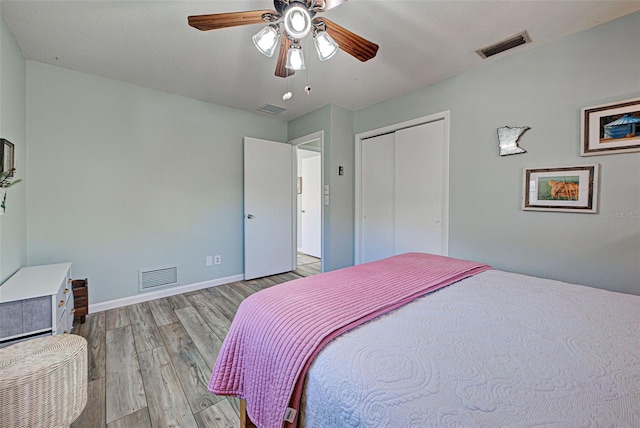 bedroom featuring ceiling fan, a closet, and light hardwood / wood-style flooring