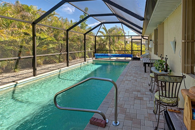 view of swimming pool with a lanai and a patio area