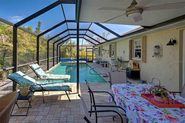 view of pool with a lanai, ceiling fan, and a patio area