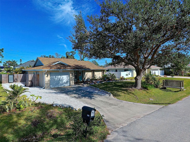 ranch-style house with a garage and a front yard