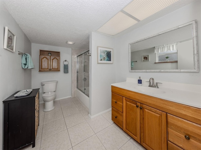 full bathroom featuring toilet, bath / shower combo with glass door, a textured ceiling, vanity, and tile patterned flooring