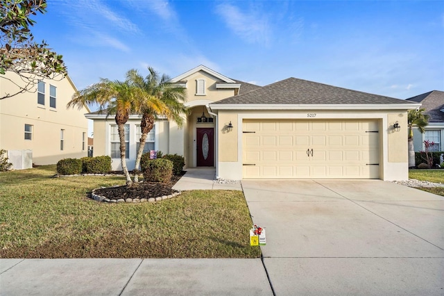 view of front facade featuring a garage and a front lawn