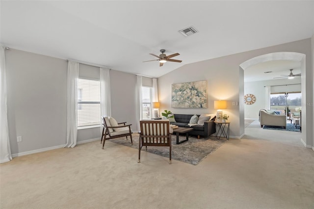 carpeted living room with vaulted ceiling and ceiling fan