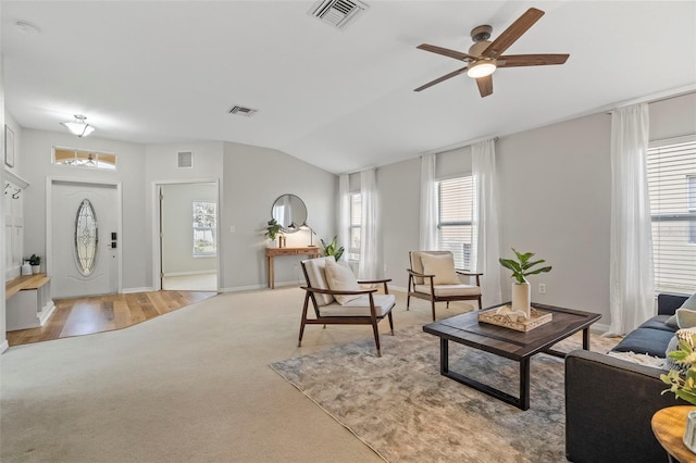 living room with light carpet, lofted ceiling, and ceiling fan