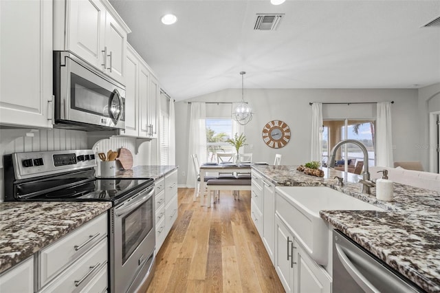 kitchen featuring white cabinetry, sink, stone countertops, and appliances with stainless steel finishes