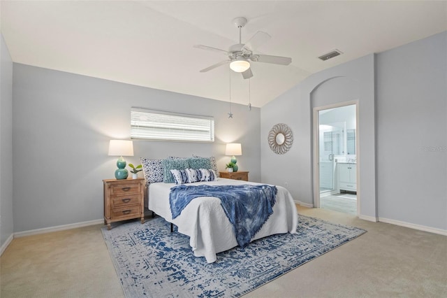 carpeted bedroom with lofted ceiling, ensuite bath, and ceiling fan