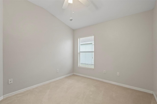 carpeted spare room with ceiling fan and lofted ceiling