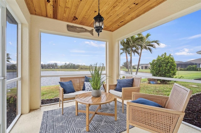 sunroom with a water view and wooden ceiling