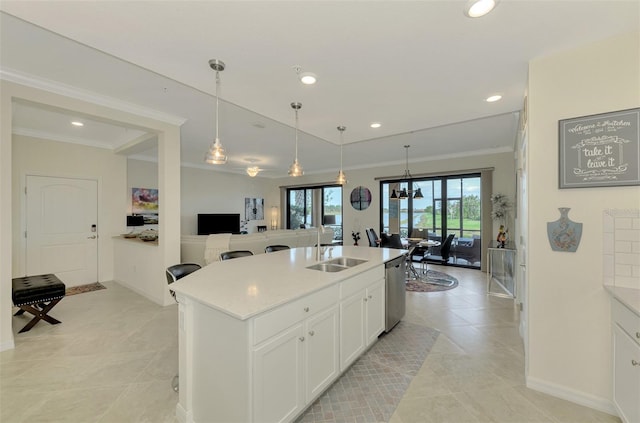 kitchen featuring an island with sink, dishwasher, white cabinets, hanging light fixtures, and crown molding