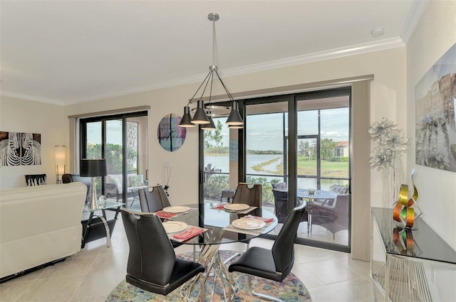 tiled dining space featuring crown molding and a water view