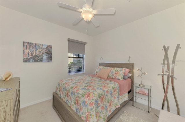 bedroom with ceiling fan and light carpet