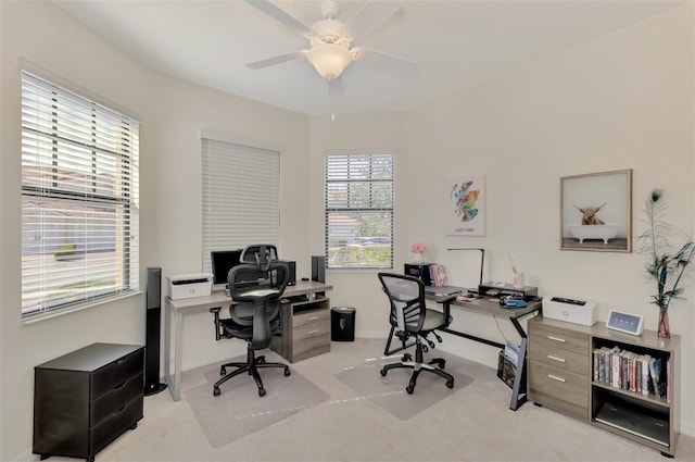 carpeted office space with ceiling fan