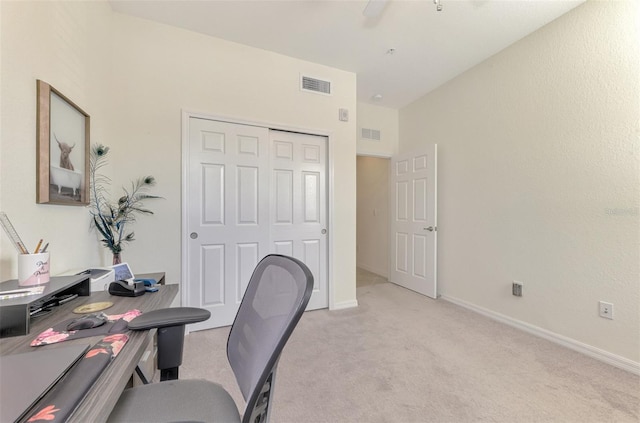 office space with light colored carpet and ceiling fan