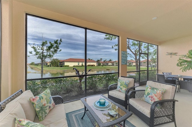 sunroom / solarium with a water view