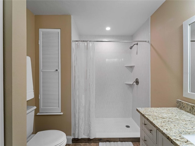 bathroom with vanity, toilet, and curtained shower