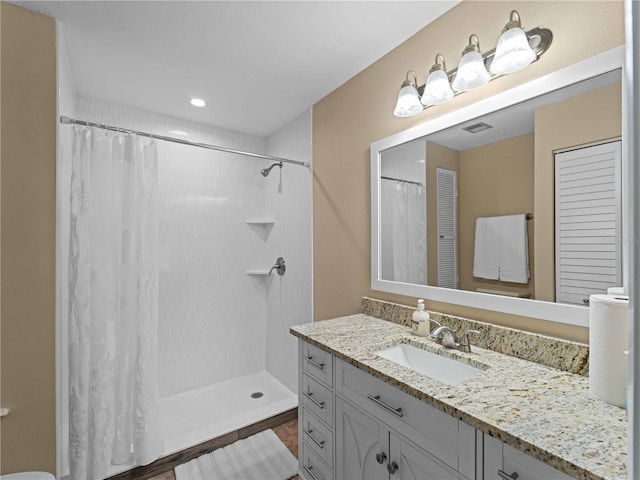 bathroom featuring vanity and curtained shower