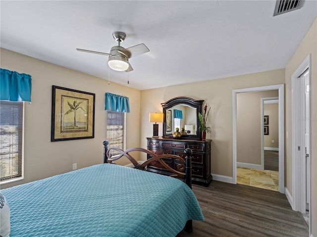 bedroom with ceiling fan and dark hardwood / wood-style flooring