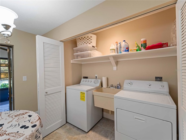 clothes washing area with washing machine and dryer