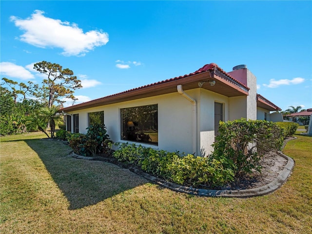 view of property exterior featuring a lawn