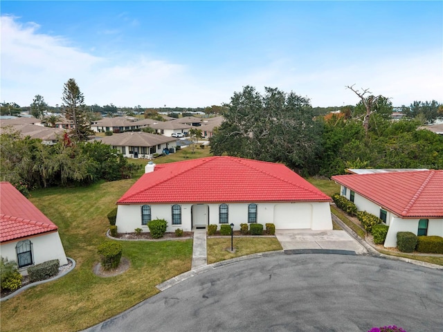 view of front of property with a garage and a front lawn