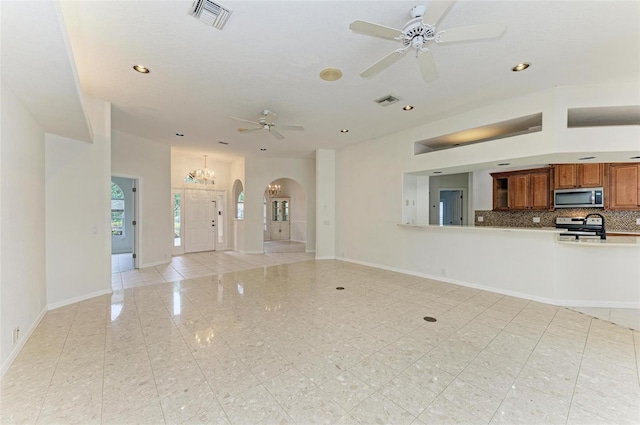 unfurnished living room with ceiling fan