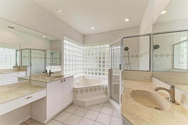 bathroom with vanity, separate shower and tub, tile patterned floors, and a textured ceiling