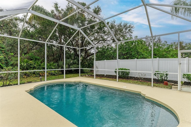 view of pool featuring a patio area and glass enclosure