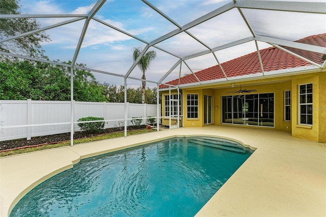 view of pool featuring ceiling fan, a lanai, and a patio