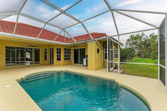 view of pool with ceiling fan, a yard, a lanai, and a patio